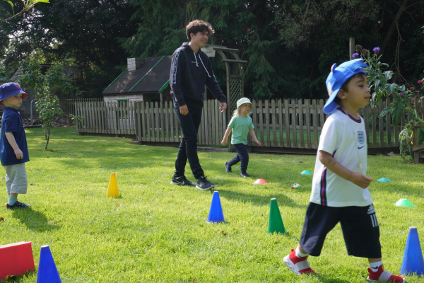 Early Years Practitioner Teaching Children outdoor games