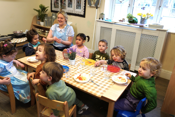 Early Years Educator having lunch with children